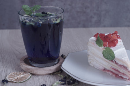Teh Bunga Telang, Butterfly pea tea with dry lemon with a slice of cake, Selective Focus
