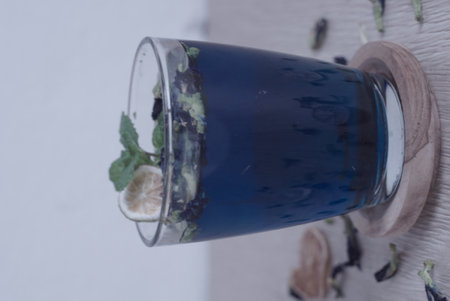 Teh Bunga Telang, Butterfly pea tea with dry lemon with a slice of cake, Selective Focus