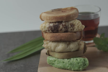 Kue Pukis are traditional Indonesian cakes. Made with a simple batter of eggs, sugar, and flour, these round treats are a sweet addition to any snack time. Enjoy with a cup of tea or coffee.の写真素材