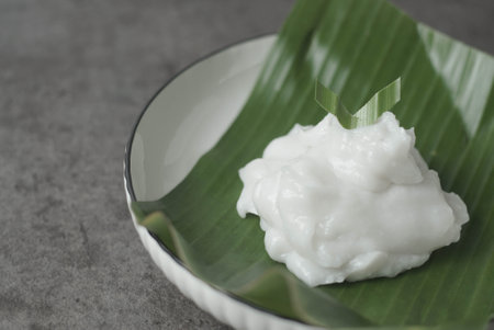 Bubur sum sum or Bubur merah putih.Traditional Indonesian dessert made from sweet glutinous rice, coconut milk, and pandanus leaf, topped with a sprinkle of red and white sugar.の写真素材