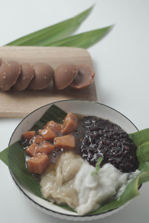 Bubur sum sum or Bubur merah putih.Traditional Indonesian dessert made from sweet glutinous rice, coconut milk, and pandanus leaf, topped with a sprinkle of red and white sugar.の写真素材