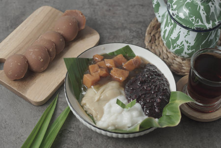 A traditional Indonesian dish, Bubur Merah Putih is made with boiled red rice, coconut milk, and sugar. Served with tea, this comforting dessert is a surefire crowd-pleaser.の写真素材