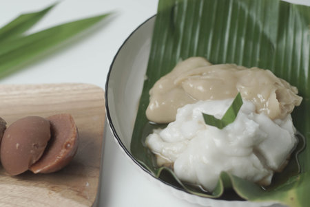 Bubur sum sum or Bubur merah putih.Traditional Indonesian dessert made from sweet glutinous rice, coconut milk, and pandanus leaf, topped with a sprinkle of red and white sugar.の写真素材