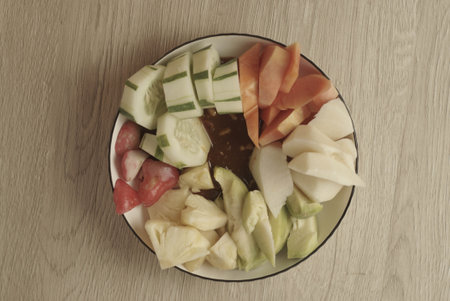 Rujak Buah is an Indonesian dessert consisting of fresh tropical fruit. That is mixed with a sweet and spicy sauce made from palm sugar, tamarind, chili, garlic and salt. Selective focus , Closeupの写真素材