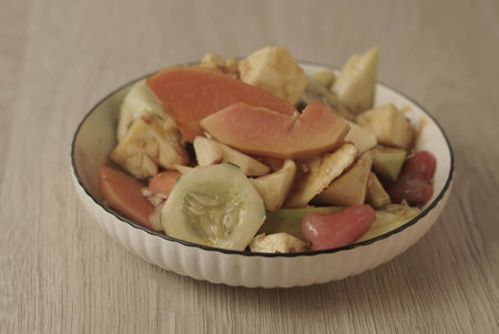 Rujak Buah is an Indonesian dessert consisting of fresh tropical fruit. That is mixed with a sweet and spicy sauce made from palm sugar, tamarind, chili, garlic and salt. Selective focus , Closeupの写真素材