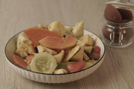 Rujak Buah is an Indonesian dessert consisting of fresh tropical fruit. That is mixed with a sweet and spicy sauce made from palm sugar, tamarind, chili, garlic and salt. Selective focus , Closeupの写真素材