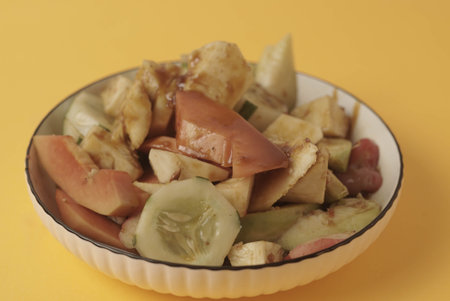 Rujak Buah is an Indonesian dessert consisting of fresh tropical fruit. That is mixed with a sweet and spicy sauce made from palm sugar, tamarind, chili, garlic and salt. Selective focus , Closeupの写真素材