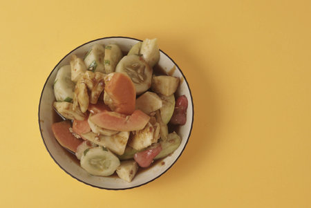 Rujak Buah is an Indonesian dessert consisting of fresh tropical fruit. That is mixed with a sweet and spicy sauce made from palm sugar, tamarind, chili, garlic and salt. Selective focus , Closeupの写真素材