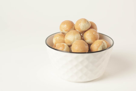 Kue nastar , This golden-brown treat is filled with a mouth-watering blend of buttery goodness and tangy pineapple jam, perfectly balanced to create a delectable flavor that's hard to resist.の写真素材
