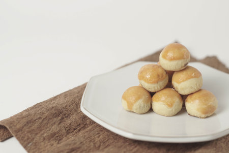 Kue nastar , This golden-brown treat is filled with a mouth-watering blend of buttery goodness and tangy pineapple jam, perfectly balanced to create a delectable flavor that's hard to resist.の写真素材