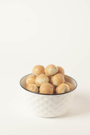 Kue nastar , This golden-brown treat is filled with a mouth-watering blend of buttery goodness and tangy pineapple jam, perfectly balanced to create a delectable flavor that's hard to resist.の写真素材