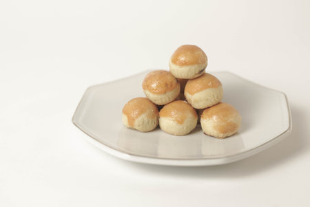 Kue nastar , This golden-brown treat is filled with a mouth-watering blend of buttery goodness and tangy pineapple jam, perfectly balanced to create a delectable flavor that's hard to resist.の写真素材