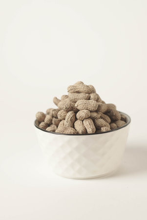 This high-quality image showcases perfectly roasted peanuts isolated on a clean white background, perfect for your food-related projects or blogsの写真素材