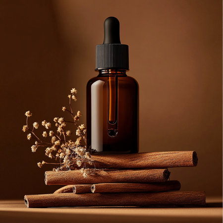 Essential oil in a glass bottle with cinnamon sticks on a brown backgroundの素材