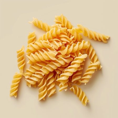 Uncooked fusilli pasta on a light background, top viewの素材