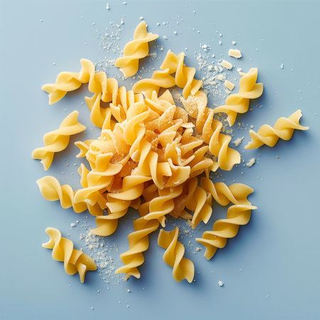 Uncooked italian pasta fusilli on blue background, top viewの素材