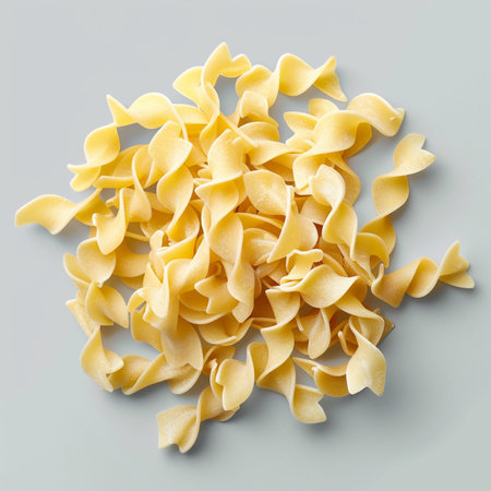 Uncooked italian pasta fusilli on grey background, top viewの素材