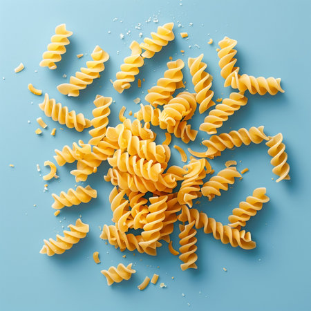 Fusilli pasta on blue background. Top view. Flat layの素材