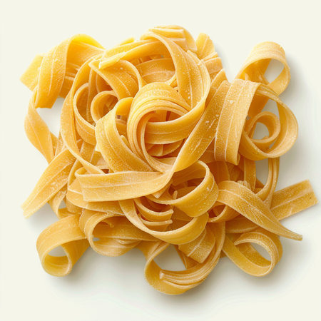 Italian pasta fettuccine nest on white background, top viewの素材