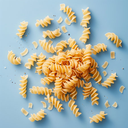 close up of uncooked fusilli pasta on a blue backgroundの素材