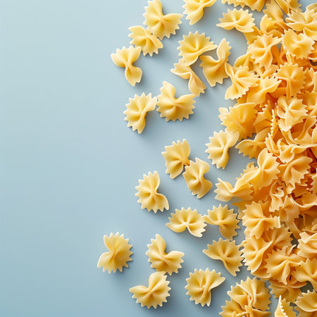 Farfalle pasta on blue background. Top view. Flat lay.の素材