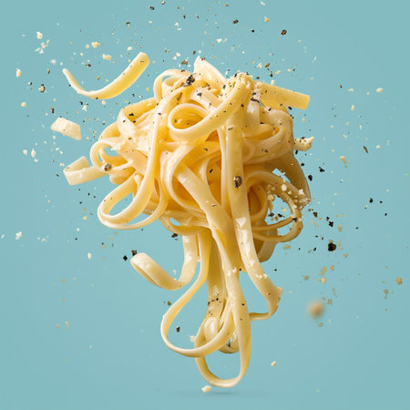 Spaghetti pasta with black pepper and parmesan on blue backgroundの素材