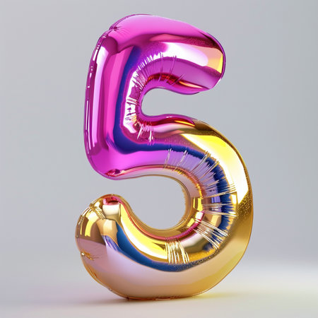 A shiny metallic balloon in the shape of the number 5, with vibrant pink and gold colors, floats against a simple gray studio background.の素材