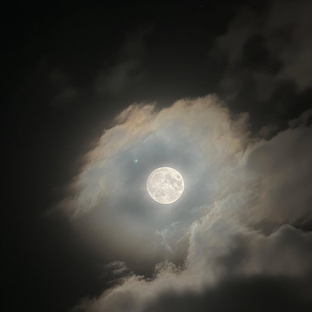 Full moon in the dark night sky with clouds. Nature background.の素材