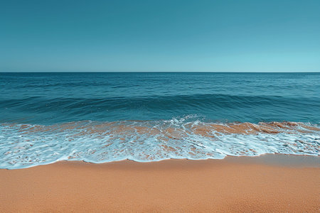 A serene beach scene with clear blue sky, calm ocean, and golden sand, showcasing a tranquil coastal landscape.の素材