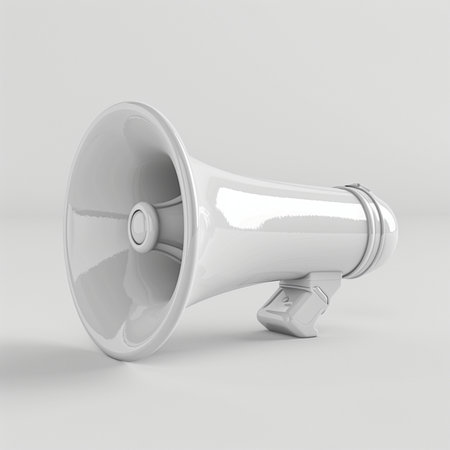 A modern, glossy white megaphone with a simple design is placed on a neutral light gray surface, isolated against a plain background.の素材