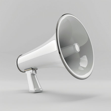 A sleek, white megaphone with a polished metallic rim rests on a neutral grey surface, isolated against a plain backdrop.の素材