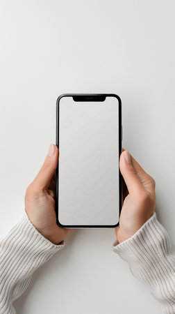 Female hands holding smartphone with blank screen on white background, mockupの素材