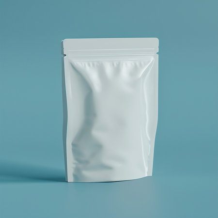 Blank white sachet package mockup isolated on blue background. 3d renderingの素材