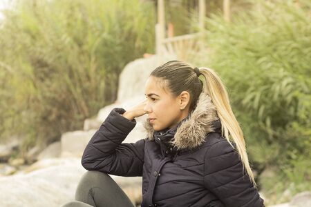 Beautiful profile portrait. Young girl, autumnal mood, sky outside the city. The port is abrasive against the bottom. Romantic mood that affectsの写真素材