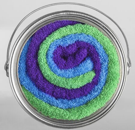 Can of paint mixing colors and textures, bath towels mixの写真素材
