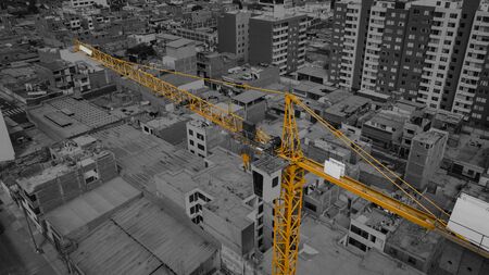 Construction site with cranes against the background of the evening sky, silhouetted at sunriseの写真素材