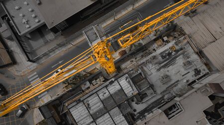 Construction site with cranes against the background of the evening sky, silhouetted at sunriseの写真素材