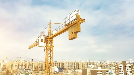 Construction site with cranes against the background of the evening sky, silhouetted at sunriseの写真素材