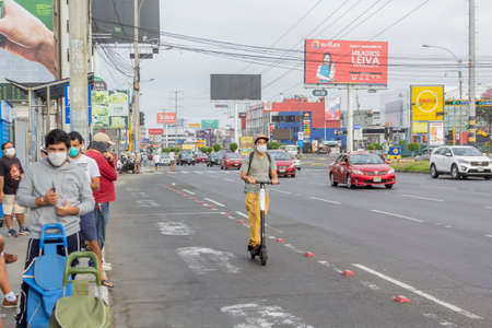Lima, Peru - April 8, 2020: Men in line doing social distancing practices in the middle of a coronavirus outbreak in South America. Men's day only, gender-based quarantine, men lined up to buy groceries.のeditorial素材
