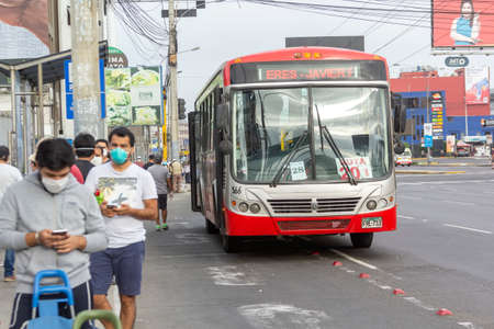 Lima, Peru - April 8, 2020: Men in line doing social distancing practices in the middle of a coronavirus outbreak in South America. Men's day only, gender-based quarantine, men lined up to buy groceries.のeditorial素材