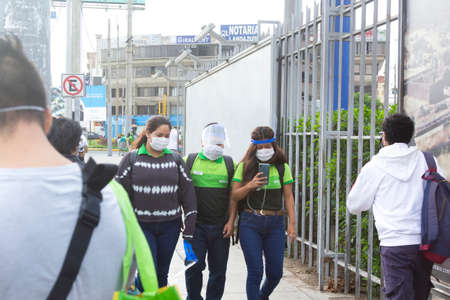 Lima, Peru - April 8 2020: Tottus supermarket workers wearing masks amid coronavirus outbreak in South America. Organizing outside a store in COVID-19 times.のeditorial素材