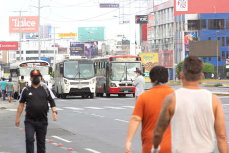 Lima, Peru - April 8 2020: Bus passengers wearing a mask, public transportation in Lima amid a coronavirus outbreak.のeditorial素材