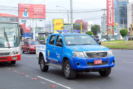 Lima, Peru - April 8 2020: Officer guards and police wearing masks patrolling amid coronavirus outbreak in South America.のeditorial素材