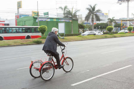 Lima, Peru - April 8, 2020: Man with a bicycle mask in the middle of a coronavirus outbreak in South America. Buying food in times of pandemic.のeditorial素材