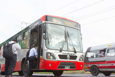 Lima, Peru - April 8 2020: Bus passengers wearing a mask, public transportation in Lima amid a coronavirus outbreak.のeditorial素材
