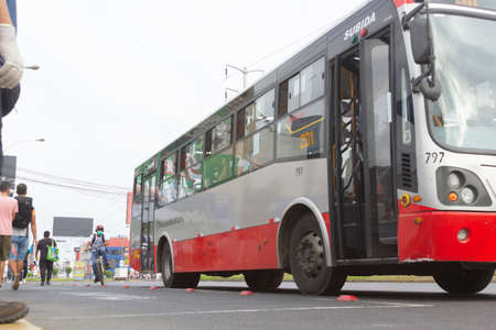 Lima, Peru - April 8 2020: Bus passengers wearing a mask, public transportation in Lima amid a coronavirus outbreak.のeditorial素材