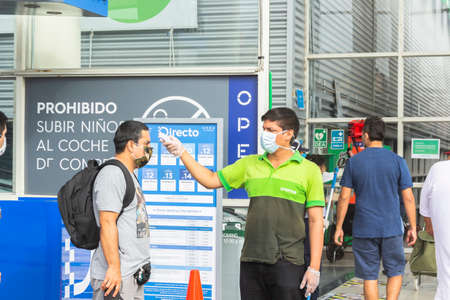 Lima, Peru - April 8 2020: Epidemic coronavirus. temperature control before entering the supermarket in Tottus. Safety procedures.のeditorial素材