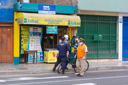 Lima, Peru - April 8, 2020: Control point with army, military and municipal police to verify circulation permit in curfew by covid coronavirus outbreak in south America.のeditorial素材
