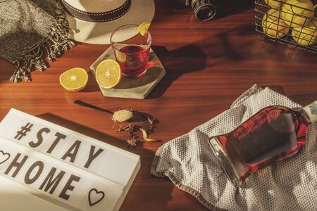 Rum bottle, glasses and oranges, hat on wooden table, selective focus, notebook and glasses on office desk.の写真素材