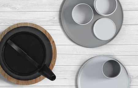 Modern black cast iron teapot with levitating cups, art set for tea time. 3d rendering.の写真素材
